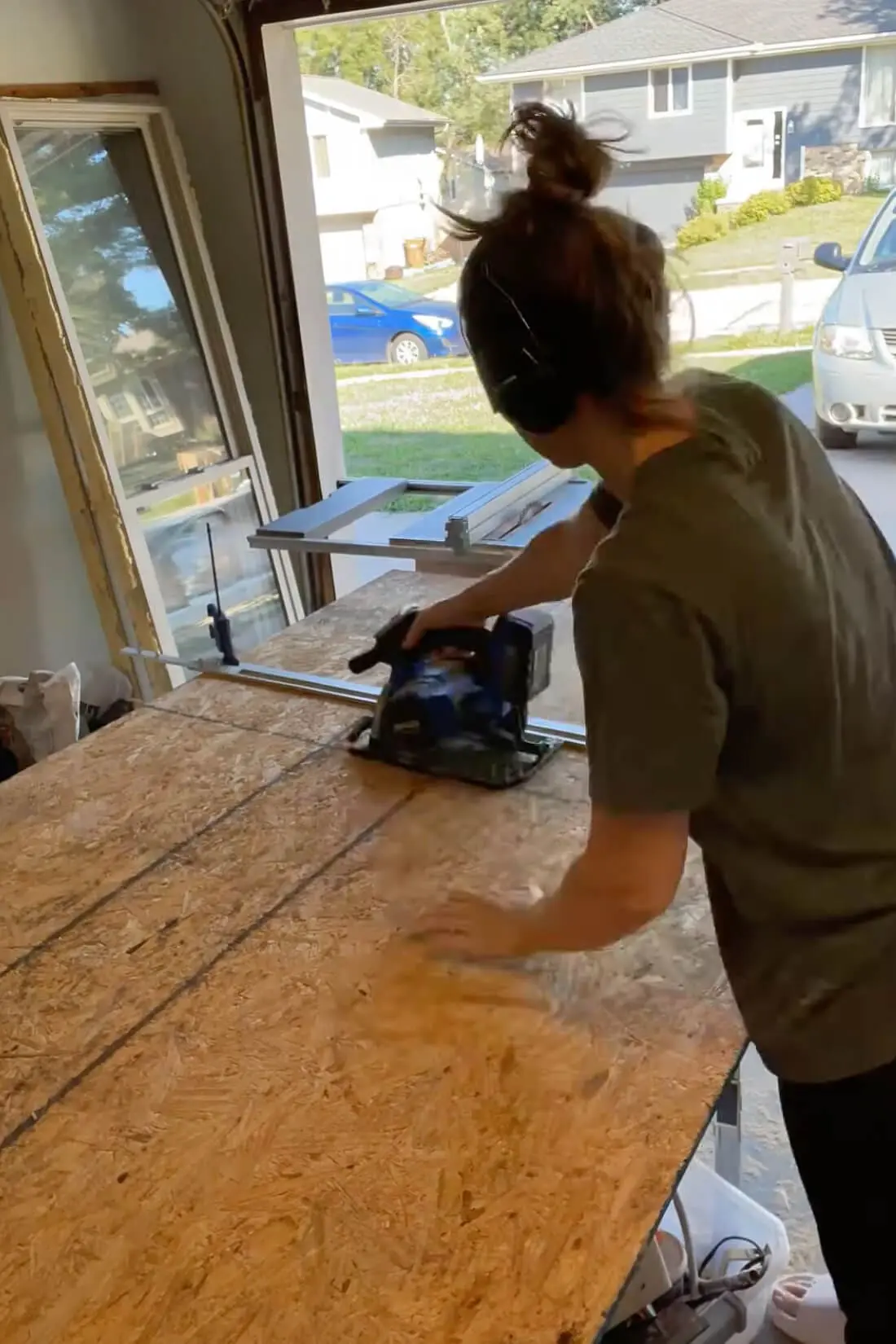 Cutting OSB sheeting with a circular saw to cover the framed fireplace wall.